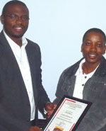Mothibi Thabeng, branch vice-chairman, (right) hands the certificate of appreciation to Clive Roberts.